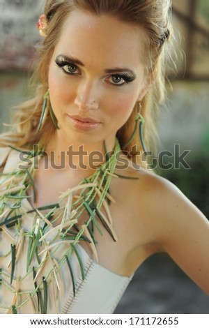 Attractive Blond woman with green bamboo nacklace on her chest