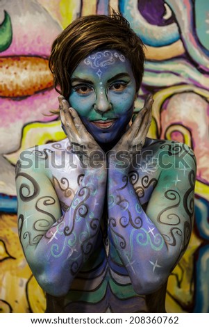 NEW YORK - JULY 26: Nude models, artists take to New York City streets during first official Body Painting Event featuring artist Andy Golub on July 26, 2014 in New York NY