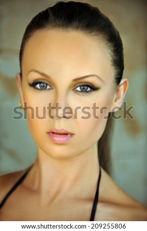 Outdoor portrait of a beautiful young woman with natural makeup.