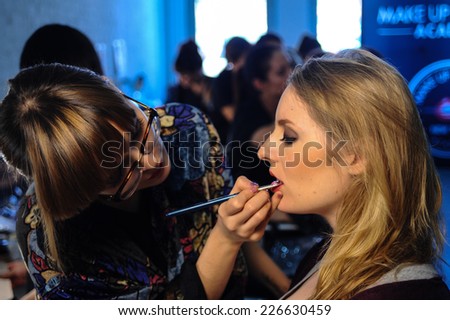 NEW YORK, NY - OCTOBER 25: Models getting ready backstage with makeup and hair during Made in the USA Spring 2015 lingerie showcase preparations at the Center 548 on October 25, 2014 in New York City