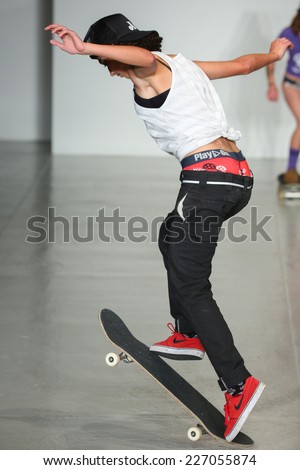 NEW YORK, NY - OCTOBER 25: A model jump skateboard on runway during Play Out Spring 2015 underwear collection at the Center 548 on October 25, 2014 in New York City.