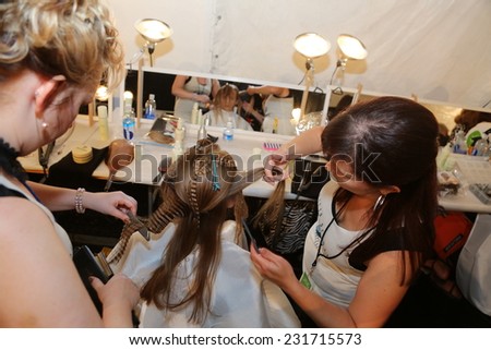 NEW YORK, NY - SEPTEMBER 06: A model has her hair done backstage at Venexiana during Mercedes-Benz Fashion Week Spring 2015 at Lincoln Center on September 6, 2014 in NYC