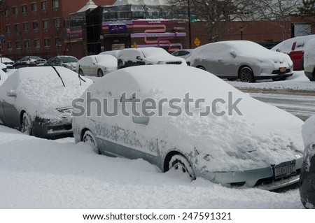 NEW YORK JANUARY 27: A car remains buried in the snow on Emmons Ave in the Broooklyn, New York on Tuesday, January 27, 2015, the day after the snow blizzard of 2015.