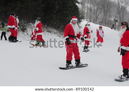WINDHAM, NY -  DECEMBER 19: Unidentified skiers take to the slopes during the Skiing and Riding Santas charity at Windham Mountain in Windham, NY on December 19, 2010. Skiers must be in full Santa costume to participate and proceeds benefit the local food