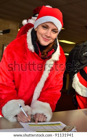 Sexy santa helper signing release form