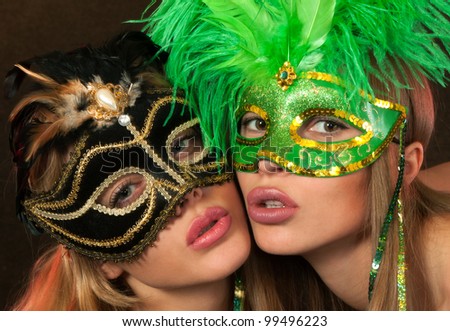 Two International beauty pageant winners posing sexy in lingerie and carnival masks