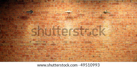 Wall of brick illuminated by three lighting equipments