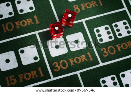 Casino dice roll snake eyes on a craps table felt