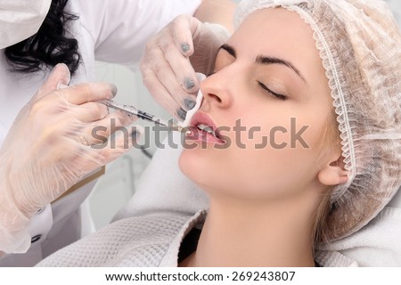Beautiful girl on rejuvenation procedure in beauty clinic, filler injection.