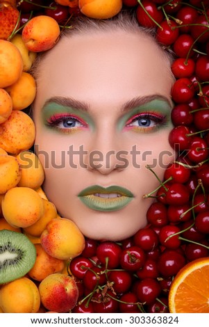 Woman face in fruits, healthy nutrition and diet concept.