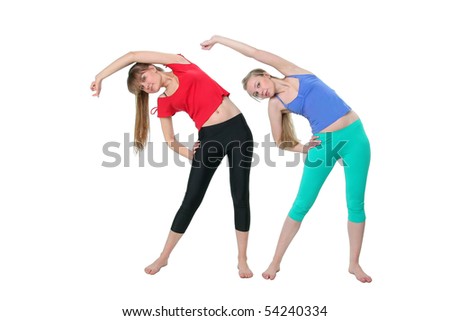 Two girls do exercise, the right hand on a waist, left upwards and to the right, the case to the right a white background