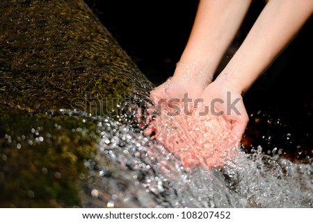 Woman\'s hands with water splash