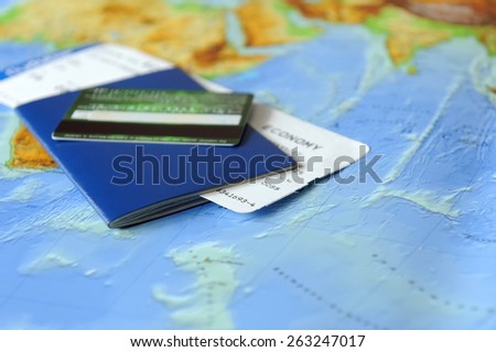 Passport and ticket  on a background map of the world. Traveling concept