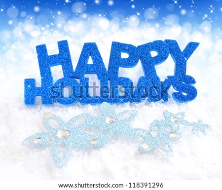 Inscription of happy holidays is on snow on a festive background