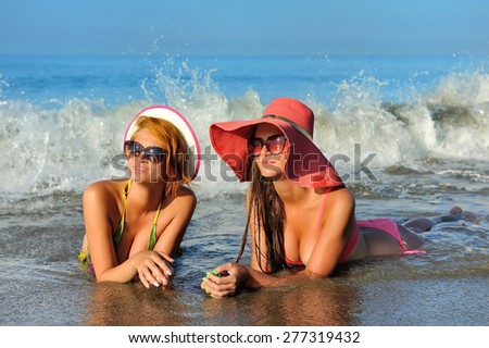 Beautiful girls resting at the sea