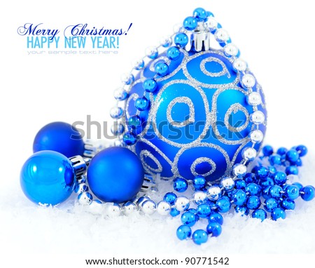 Blue and silver christmas decoration baubles on white with space for text