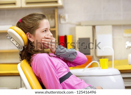 Little girl is being scared at the dentist