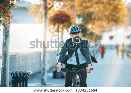 Hipster businessman commuter with electric bicycle traveling home from work in city. Imagine de stoc © 