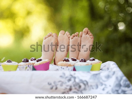 Two happy feet having picnic outside in summer