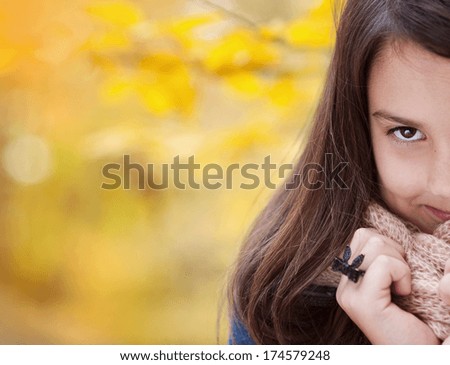Cute girl in warm autumn clothes relaxing colorful autumn nature