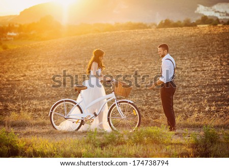 Beautiful bride and groom wedding portrait with white bike