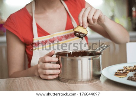 Woman is making christmas cakes in the kitchen