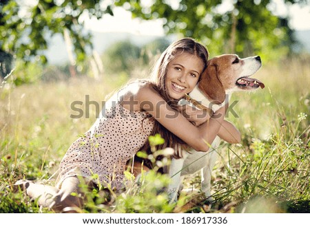 Portrait of a teenage girl with her beautiful dog outdoors