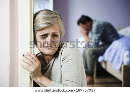 Mature woman with black eye is victim of domestic violence and abuse.