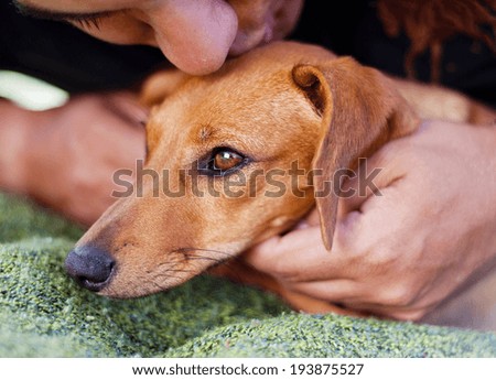 Close-up of young man hugging his dog