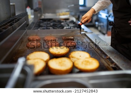 Similar – Image, Stock Photo Chef preparing burgers at grill plate on international urban street food festival.