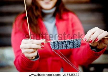 Close up portrait of winter girl knitting