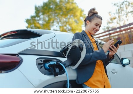 Image, Stock Photo woman charging batteries in the middle of nature