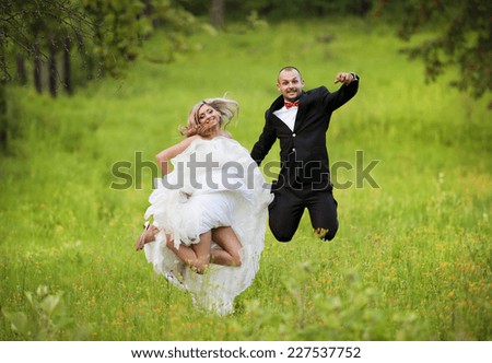 Happy bride and groom enjoying their wedding day in green nature