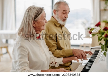 Similar – Image, Stock Photo Woman playing piano in living room