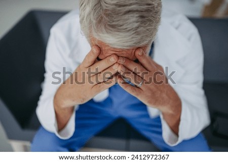 Similar – Image, Stock Photo Sad, exhausted doctor sitting in a dark room