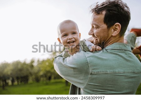 Similar – Image, Stock Photo Toddler playing with a colorful plastic bug toy; using hands to manipulate small object developmental milestone