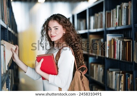 Similar – Image, Stock Photo Young female student in a university library