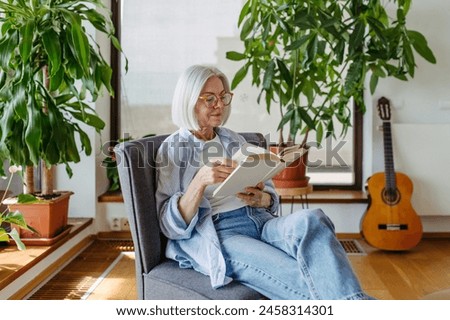 Similar – Image, Stock Photo A woman reads a book