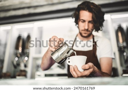 Similar – Image, Stock Photo Barista preparing a coffee at the sieve carrier machine in a café