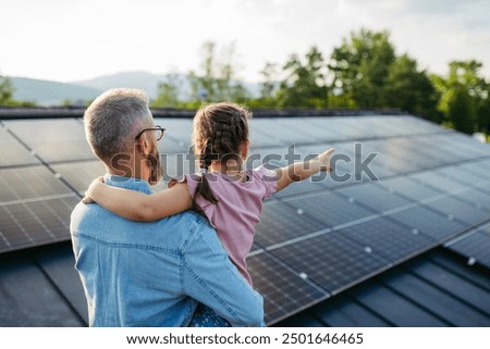 Similar – Image, Stock Photo Solar system on the roof with snow in winter. Remove snow from solar panels in winter. Remove snow photovoltaic system