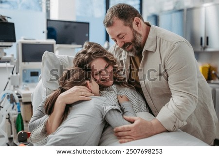 Similar – Image, Stock Photo Husband and daughter visiting senior woman in hospital