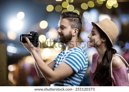Trendy young hipster couple enjoying nightlife in the city