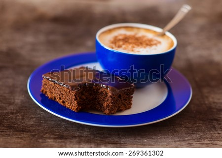 Cup of coffee on a wooden table background