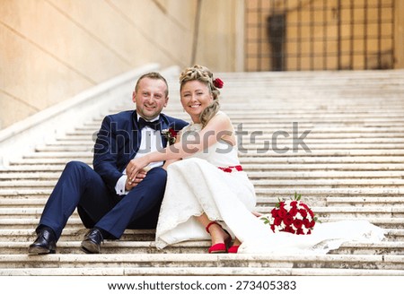 Beautiful wedding couple outside the castle on the stairs