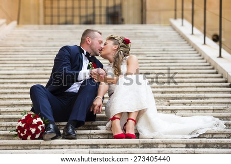 Beautiful wedding couple outside the castle on the stairs