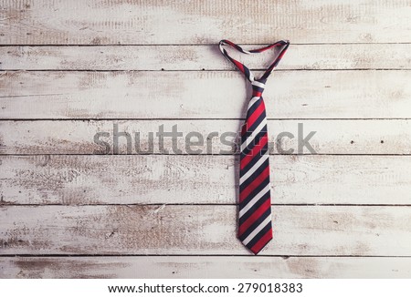 Fathers day composition of colorful tie hang on wooden wall backround.