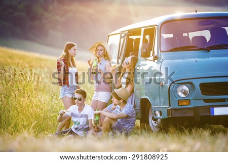 Young hipster friends on road trip on a summers day
