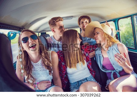 Young hipster friends on a road trip on a summers day