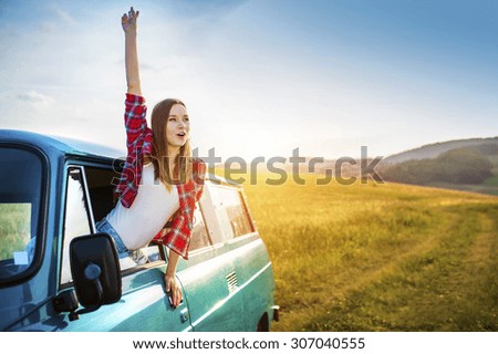 Teenage girl and her friends on a road trip on a summers day