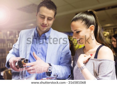 Beautiful young couple enjoying a drink in bar